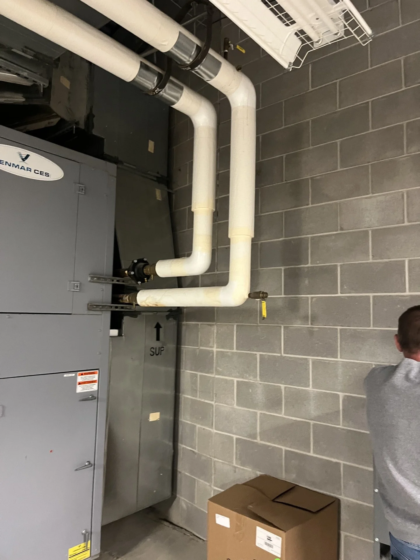Heat recovery unit with new insulated hydronic piping in a Cooper High School mechanical room